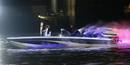 Britains David Beckham drives a powerboat with the Olympic torch as fireworks are launched over Tower Bridge during the opening ceremony of the London 2012 Olympic Games