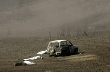 Blackened corpses lay beside charred vehicle after deadly forest fire in central Spain. Blackened corpses lay beside charred vehicle after deadly forest fire in central Spain.
