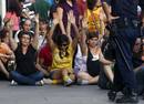 Demonstrators raise their arms as they sit during a protest before Spanish National Police officers removed them from Madrids Puerta del Sol square