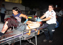 An Israeli paramedic rushes a wounded man to an ambulance after a shooting incident in Tel Aviv An Israeli paramedic rushes a wounded man to an ambulance after a shooting incident in Tel Aviv