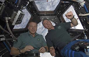  Robert L. Curbeam, Jr. of NASA, aa left, and Christer Fuglesang of ESA during one of the spacewalks devoted to the assembly of the ISS 