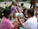 A man comforts a relative after an earthquake hit Padang, on Indonesias Sumatra island