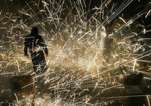 A man stands surrounded by fireworks during the San Ildefonso festivity in Olula del Rio southeast Spain