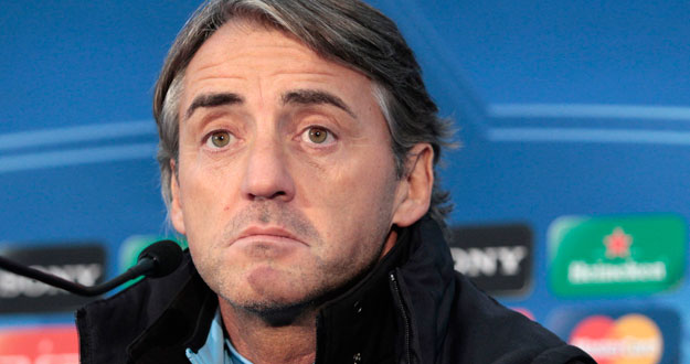 Manchester City's coach Roberto Mancini gestures during a news conference at the club's Carrington training complex in Manchester, northern England