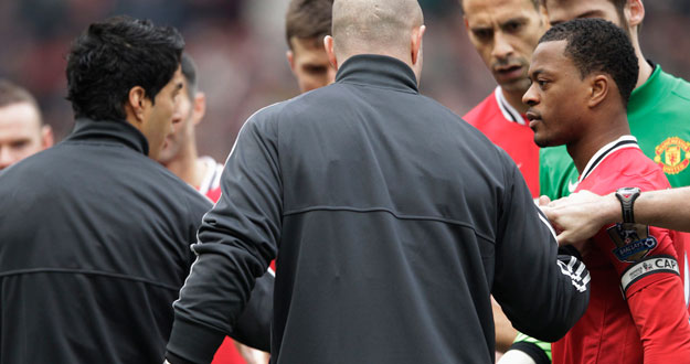 Manchester United's Evra reacts after Liverpool's Suarez ignored his handshake before their English Premier League soccer match in Manchester