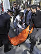 The body of a victim of a shooting at a university is carried to a van in Baku