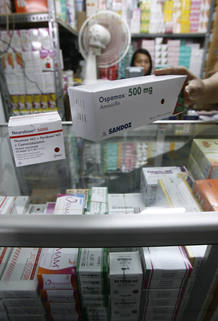 A pharmacy staff checks newly arrived packages of drugs at a market in Jakarta