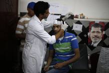A medic treats a wounded supporter of deposed Egyptian President Mohamed Mursi at a local hospital in Cairo
