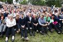 Members of AUF sit with guests and relatives of those who died a year ago, at the Utoeya island