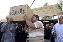 Men carry the coffin of a victim, killed in one of Thursday's bomb attacks, during a funeral in Sadr City, northeastern Baghdad