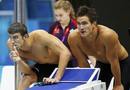 Michael Phelps and Nathan Adrian of the U.S. watch a swimmer during the mens 4x100m freestyle relay final during the London 2012 Olympic Games at the Aquatics Centre