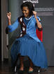 U.S. first lady Michelle Obama reacts to her applause as she arrives for a visit to Elizabeth Garrett Anderson Language School in London