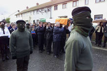 MASKED MEMBERS OF THE REAL IRA STAND TO ATTENTION AS THE COFFIN OF JOSEPH O'CONNOR IS CARRIED FROM HIS HOME. MASKED MEMBERS OF THE REAL IRA STAND TO ATTENTION AS THE COFFIN OF JOSEPH O'CONNOR IS CARRIED FROM HIS HOME.