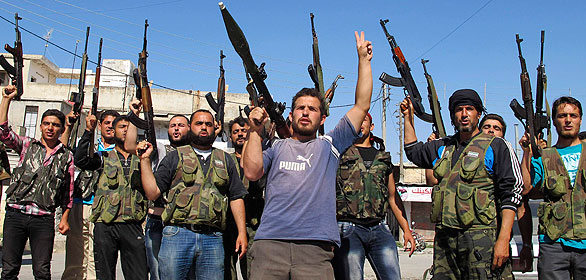 Members of the Free Syrian Army chant slogans against Syrian President Bashar al-Assad in Azzaz