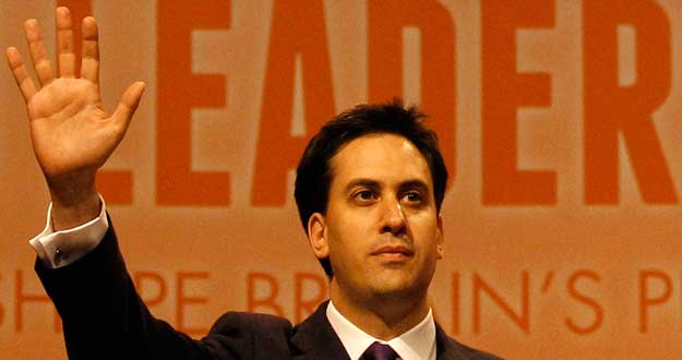 Former cabinet member Ed Miliband waves after being named the new leader of Britain's Labour Party at their annual conference in Manchester