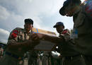 Myanmar soldiers unload boxes of medicine off a Thai military airplane after it flew into Yangon with aid supplie for cyclone victims