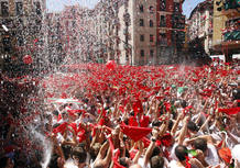Revellers hold up traditonal red scarves at the start of the San Fermin festival in Pamplona.