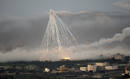 A shell fired by Israeli forces explodes over the northern Gaza