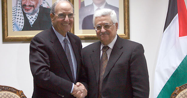 U.S. President Barack Obama's Middle East envoy Mitchell shakes hands with Palestinian President Abbas during their meeting in West Bank city of Ramallah