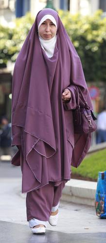 Una mujer argelina pasea con un chador, de influencia iran&iacute;.
