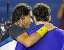 Spains Nadal puts his arm around Switzerlands Federer after Nadal won their mens singles final match at the Australian Open