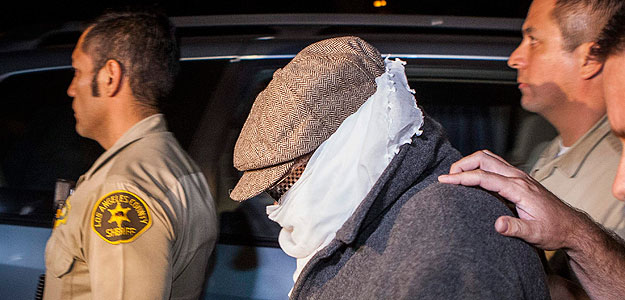 Nakoula Basseley Nakoula is escorted out of his home by Los Angeles County Sheriff's officers in Cerritos, California