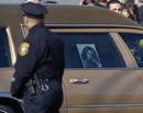 Newark Police officer watches as Houstons hearse arrives at New Hope Baptist Church in Newark