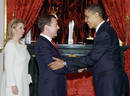 U.S. President Barack Obama and Russias President Dmitry Medvedev meet as first lady Svetlana Medvedev looks on at the Kremlin in Moscow