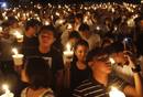 Participants hold candles as they join the celebration of Earth Hour in Manilas Makati financial district
