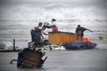 People try to recover things that are being washed away by flood in Boca Del Rio on outskirts of Veracruz