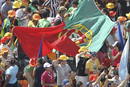 Peregrinos portugueses ondean una bandera de su pa&iacute;s mientras esperan de la llegada de Benedicto XVI