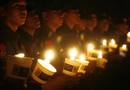 Philippine police hold candles as they join the celebration of Earth Hour in Manilas Makati financial district