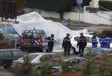 French police conduct their investigation near the car where ETA suspects shot and killed a Spanish Guardia Civil policeman in Capbreton