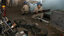 Police take up position at a blast site in Mumbai