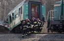 Polish emergency services workers carry the body of a victim of a train crash near the town of Szczekociny