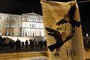 A poster depicting German Chancellor Merkel and the IMF head Lagarde hangs in front of the Greek parliament during an anti-austerity demonstration in Athens Syntagma square