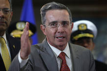 El presidente colombiano, &Aacute;lvaro Uribe, saluda durante una rueda de prensa en la casa presidencial de Tegucigalpa.
