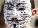 A protester wearing a mask waits for WikiLeaks founder Julian Assange to speak to the media outside the Ecuador embassy in west London
