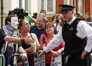 Protesters try to negotiate with police as they wait for Wikileaks founder Julian Assange to speak to the media outside the Ecuador embassy in west London