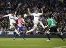 Real Madrids Higuain scores a goal in front of his teammate Pepe and Sporting Gijons Hernandez and goalkeeper Colinas during their Spanish First Division soccer match in Madrid