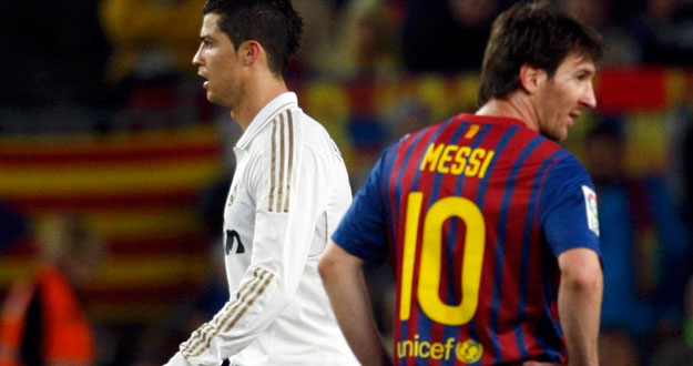 Real Madrid's Ronaldo walks past Barcelona's Messi after scoring his goal during their Spanish first division "El Clasico" soccer match