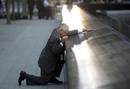 Robert Peraza, who lost his son Robert David Peraza, pauses at his sons name at the North Pool of the 9/11 Memorial during tenth anniversary ceremonies at the site of the World Trade Center in New York