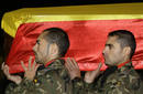 Spanish soldiers carry the coffins of R&iacute;os and Garcia at the military airport of Lavacolla in Santiago de Compostela