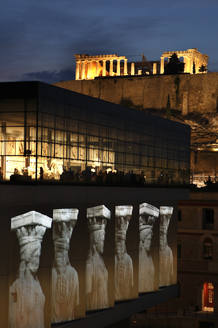 Karyatids statues are projected outside the new Acropolis Museum in Athens