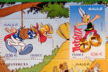 Commemorative stamps of Asterix and Assurancetourix are displayed during a news conference in Paris