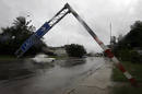 A traffic sign is seen leaning over a street after strong winds from Hurricane Ike blew across Havana