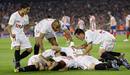Sevillas players celebrate their first goal against Atletico Madrid during their Kings Cup final soccer match at Nou Camp stadium in Barcelona