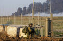 An Israeli soldier advances at the border with the northern Gaza