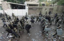 Soldiers walk outside the Brazilian embassy after dispersing supporters of ousted Honduras President Manuel Zelaya, in Tegucigalpa