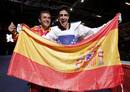 Spains Joel Gonzalez Bonilla and his coach Francisco Martin Varela celebrate with a national flag after winning his mens -58kg gold medal taekwondo match against South Koreas Lee Dae-hoon during the London 2012 Olympic Games at the ExCeL arena